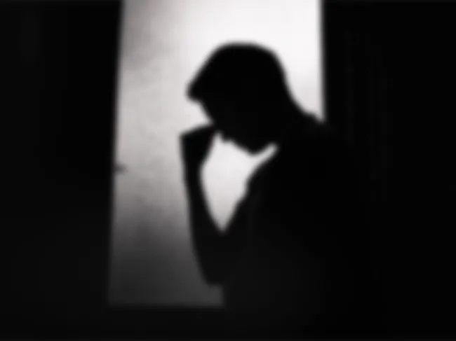 A man bows his head in despair